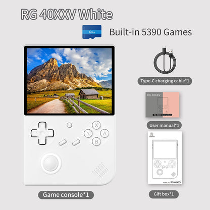 White game console with screen displaying mountain landscape, surrounded by accessories on a light gray background.